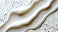Creamy white liquid waves flowing smoothly across surface with water droplets, creating elegant fluid motion for skincare and cosmetic applications.