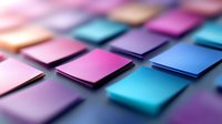 Colorful square paper notes arranged in geometric pattern with pink, purple and blue tones creating modern minimalist composition with selective focus and depth of field.