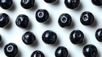 Fresh ripe blueberries arranged in geometric pattern on white background, macro shot showing natural texture and shine of berries. Isolated food photography.
