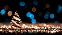 Glowing decorative Christmas tree with golden and blue bokeh lights on dark background creates magical holiday atmosphere for seasonal designs.