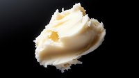 Creamy butter spread isolated on black background for culinary and cooking applications.