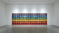 Contemporary art gallery interior with colorful grid artwork display on white wall under track lighting system for modern exhibition space design.