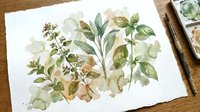 Watercolor botanical illustration of green herbs and leaves on white paper with paintbrushes and palette, artistic nature study for home decor and design.