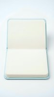 Clean white cutting board on light blue tray isolated on white background for kitchen design and culinary presentations.