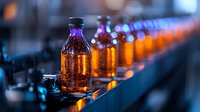 Illuminated amber bottles on production line with vibrant bokeh lights creating industrial atmosphere. Manufacturing process captured in modern facility setting.