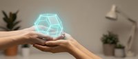 Hands holding glowing blue hexagonal hologram in modern office workspace with plants and lamp. Digital technology innovation concept for business presentations.
