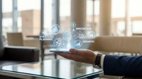 Business professional in dark suit holding tablet displaying holographic icons for strategy, planning, innovation, and growth metrics in modern office with city skyline view.