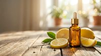 Citrus essential oil bottle with fresh lemon slices on wooden table in bright kitchen setting for natural skincare and aromatherapy wellness.