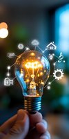 Glowing lightbulb with smart home icons floating around it against blurred background, representing innovative home automation and Internet of Things technology.