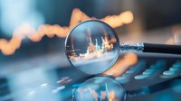 Magnifying glass focusing on financial chart with blurred stock market data in background, symbolizing investment analysis and market research.