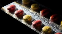 Colorful medication capsules in blister pack on dark background. Pharmaceutical pills for healthcare treatment and medical therapy concept.