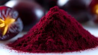 Vibrant burgundy acai berry powder heap on white surface with fresh berries in background, showcasing natural superfood supplement for healthy lifestyle and nutrition.