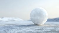Minimalist winter scene with single snowball on textured snowy ground against soft cloudy sky, creating serene natural composition for seasonal designs.