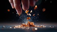 Copper metallic fragments falling and scattering on dark surface with sparkles and bokeh effect, dramatic lighting creates mystical atmosphere.