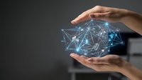 Hands holding a glowing digital network with connected nodes, symbolizing data management, cloud computing, and global connectivity.