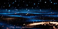 Abstract background with glowing blue and gold bokeh lights on dark surface, magical sparkles and particles creating dreamy atmospheric effect. Suitable for luxury designs.