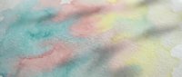 Soft pastel chalk powder in rainbow colors creating artistic texture on white paper surface for creative projects and educational activities.