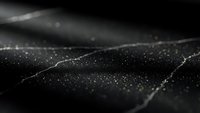 Abstract black surface with golden glitter particles and flowing waves creating luxury texture for premium design projects and elegant backgrounds.