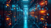 Server room corridor with glowing blue and orange lights reflecting on floor, rows of data center equipment creating futuristic perspective with bokeh effects.