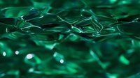 Abstract emerald green crystal formations with soft bokeh light effects create dynamic geometric shapes and reflective surfaces in macro photography.