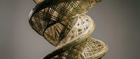 Woven bamboo baskets stacked in artistic arrangement showcasing traditional craftsmanship and natural textures for home decor and storage solutions.