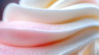 Soft flowing fabric waves in pastel pink and white colors creating elegant abstract textile background with gentle curves and smooth transitions.
