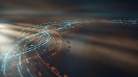 Aerial view of illuminated highway interchange at night with glowing road markings and traffic lights creating a digital network visualization effect.