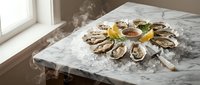 Fresh raw oysters arranged on crushed ice with lemon wedges and mignonette sauce on marble counter near window for gourmet seafood dining experience.
