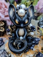 Mystical black fox creature with pearl and crystal embellishments, ornate fantasy art sculpture featuring detailed metalwork and gemstone accents against dark minerals.