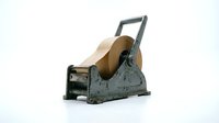 Vintage tape dispenser with brown kraft paper roll isolated on white background, ready for office and packaging design projects.