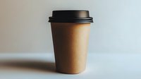 Minimalist brown paper coffee cup with black lid on light background, modern takeaway beverage container for cafe and restaurant branding mockup.