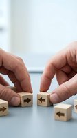 Businessman hands arranging wooden blocks with arrows showing strategic planning and direction in modern office environment for business solutions.