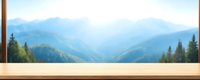 Wooden table surface against blurred mountain landscape background with pine forest and layered blue peaks, suitable for product display or mockup.