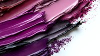 Crushed eyeshadow makeup powder in vibrant pink and purple shades with scattered pigment particles on white background for cosmetic design.