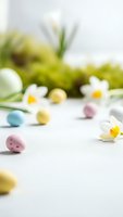 Easter spring composition with colorful eggs, white daisies and fresh green grass on light background for holiday greeting cards and seasonal decorations.
