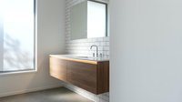 Modern floating bathroom vanity with wood grain finish and white countertop in minimalist interior with subway tile backsplash and natural lighting.