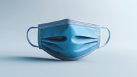 Blue surgical face mask on light background, showing pleated texture and elastic ear loops, isolated for medical and healthcare designs.