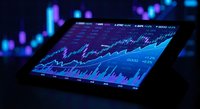 Digital tablet displaying financial trading charts and graphs with glowing blue data visualization on dark background for business analysis.