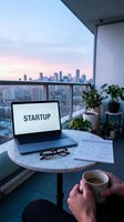 Entrepreneur working on startup business plan on balcony with city skyline at dusk, laptop, coffee, and notes on marble table.