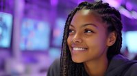 Young African American woman with braided hair smiling in neon purple lit environment with blurred digital screens, suitable for tech, gaming, and modern lifestyle content.