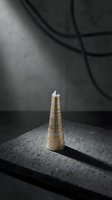 Stack of golden coins forming tower on dark concrete surface with dramatic shadows and moody lighting for financial growth concepts.