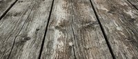 Weathered wooden planks with rustic texture and natural grain patterns creating vintage background surface for product photography and design projects.