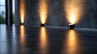 Modern minimalist wall lighting creates dramatic warm glow effect on dark textured surface, architectural interior design element with upward beam pattern.