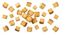 Crispy golden croutons scattered on white background, isolated and ready for food styling, recipes, cooking blogs, restaurant menus, and culinary design projects.