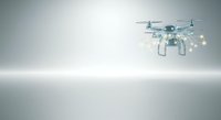 Quadcopter drone with illuminated lights hovering against neutral gray background, suitable for technology, innovation, and aerial photography concepts.