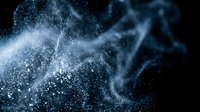 Glowing particles and light trails flow dynamically across dark background, creating ethereal wave patterns. Suitable for technology, innovation, and digital transformation concepts.