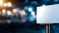 Empty white billboard against blurred city lights and bokeh background at night, space for advertising text or promotional content.