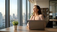 Young professional woman working on laptop in modern office with city skyline view, contemplating business strategy during productive workday.