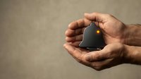 Hands gently holding small house model with warm light, symbolizing home protection, real estate investment, property care and housing security concept.