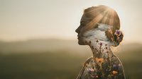 Young woman silhouette with double exposure of ocean waves and wildflowers at golden hour sunset creating dreamy artistic portrait for wellness concepts.